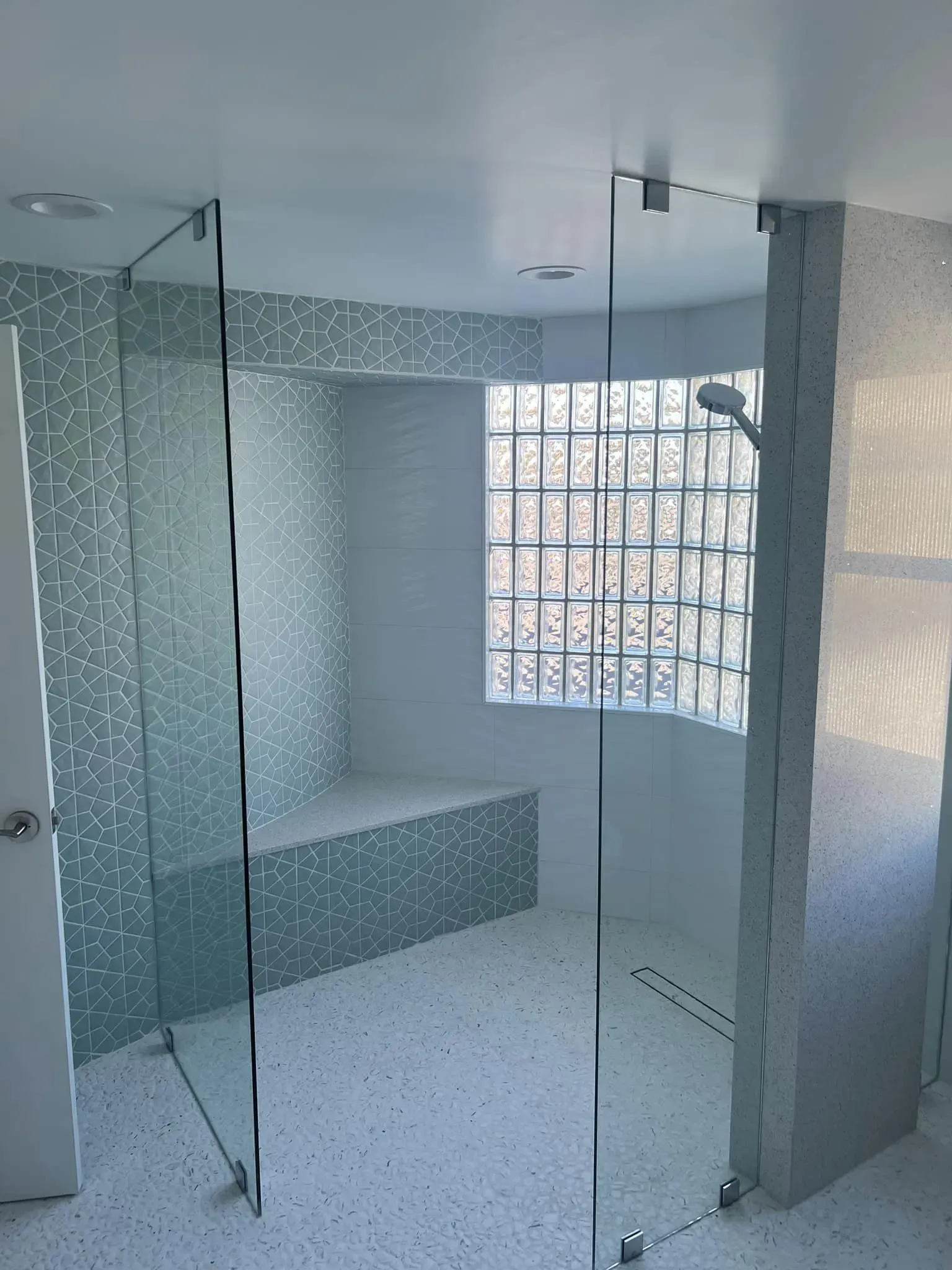 Walk-in corner shower with frameless glass