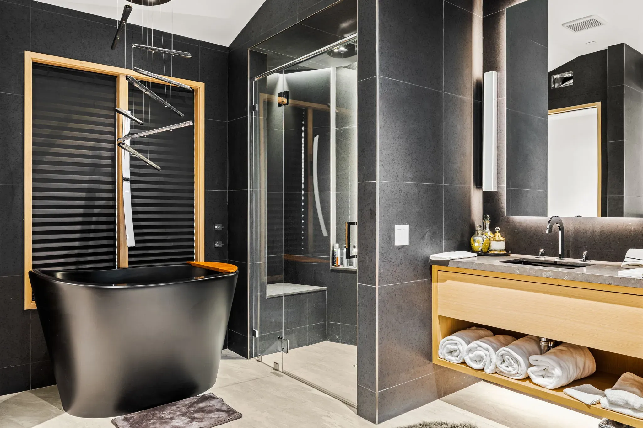 Master bathroom with freestanding black tub and walk-in shower