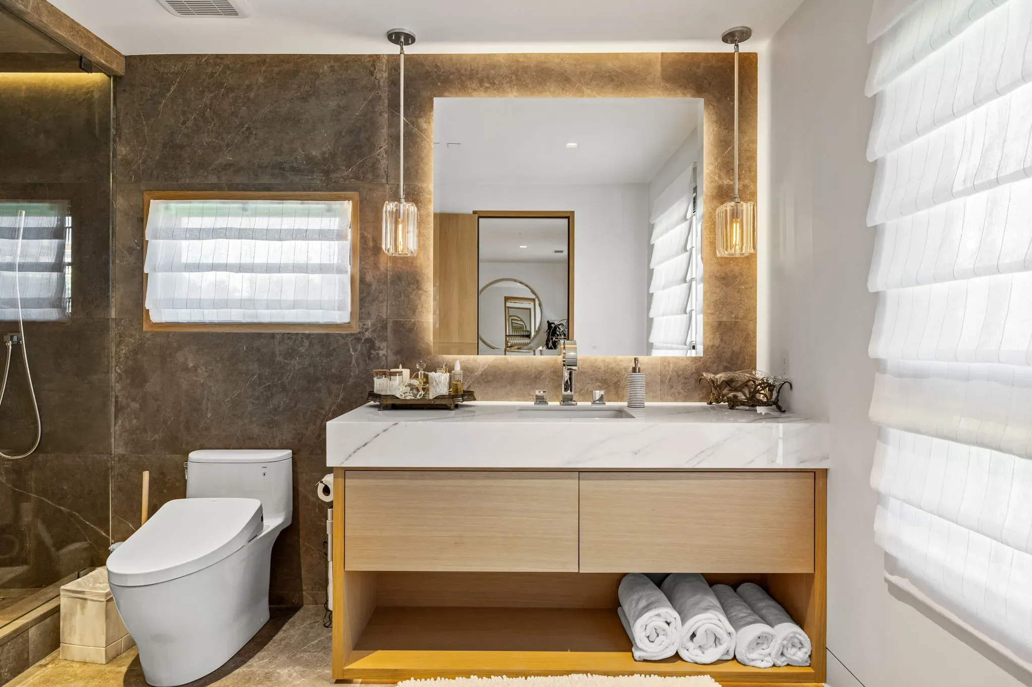 Floating vanity with quartz counter and backlit mirror