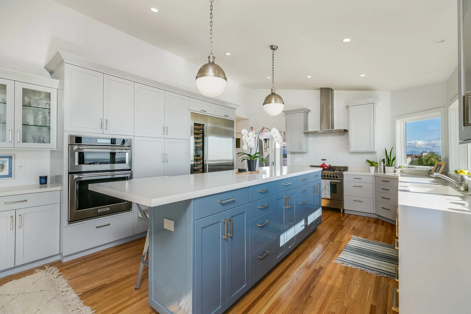 Custom kitchen with oversized island and contrasting cabinetry