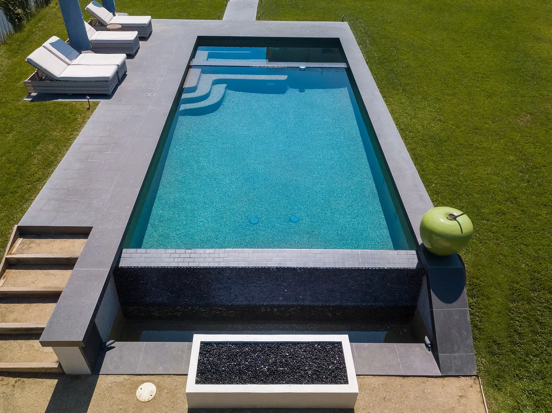 Custom infinity-edge pool, deck, and fire feature