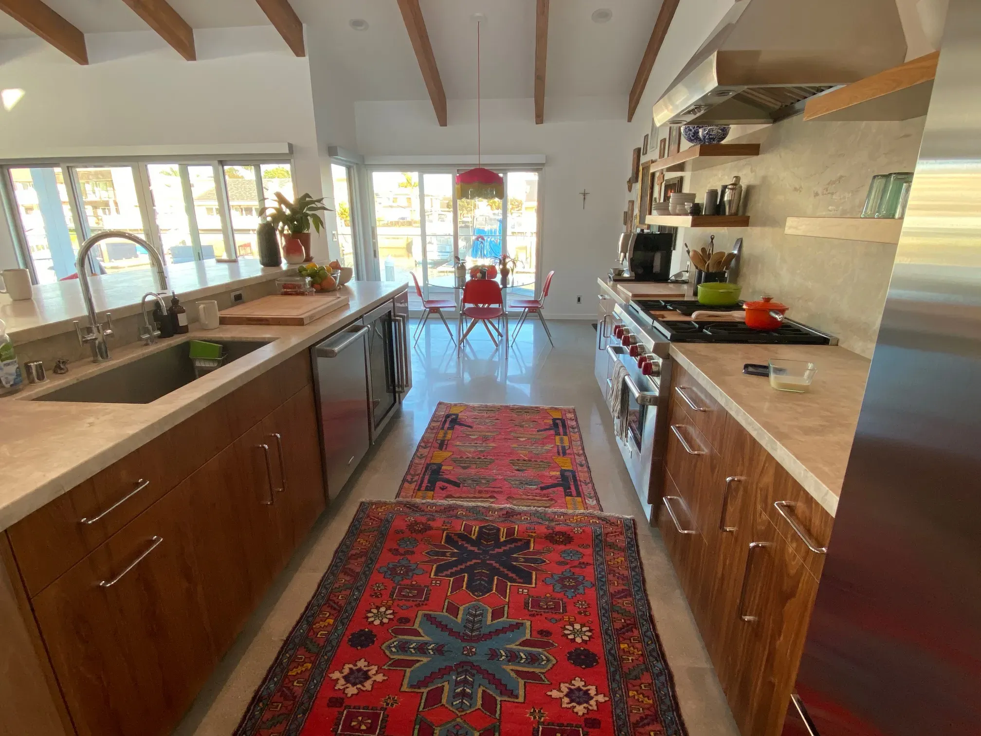 Galley view of the remodeled kitchen with stone counters