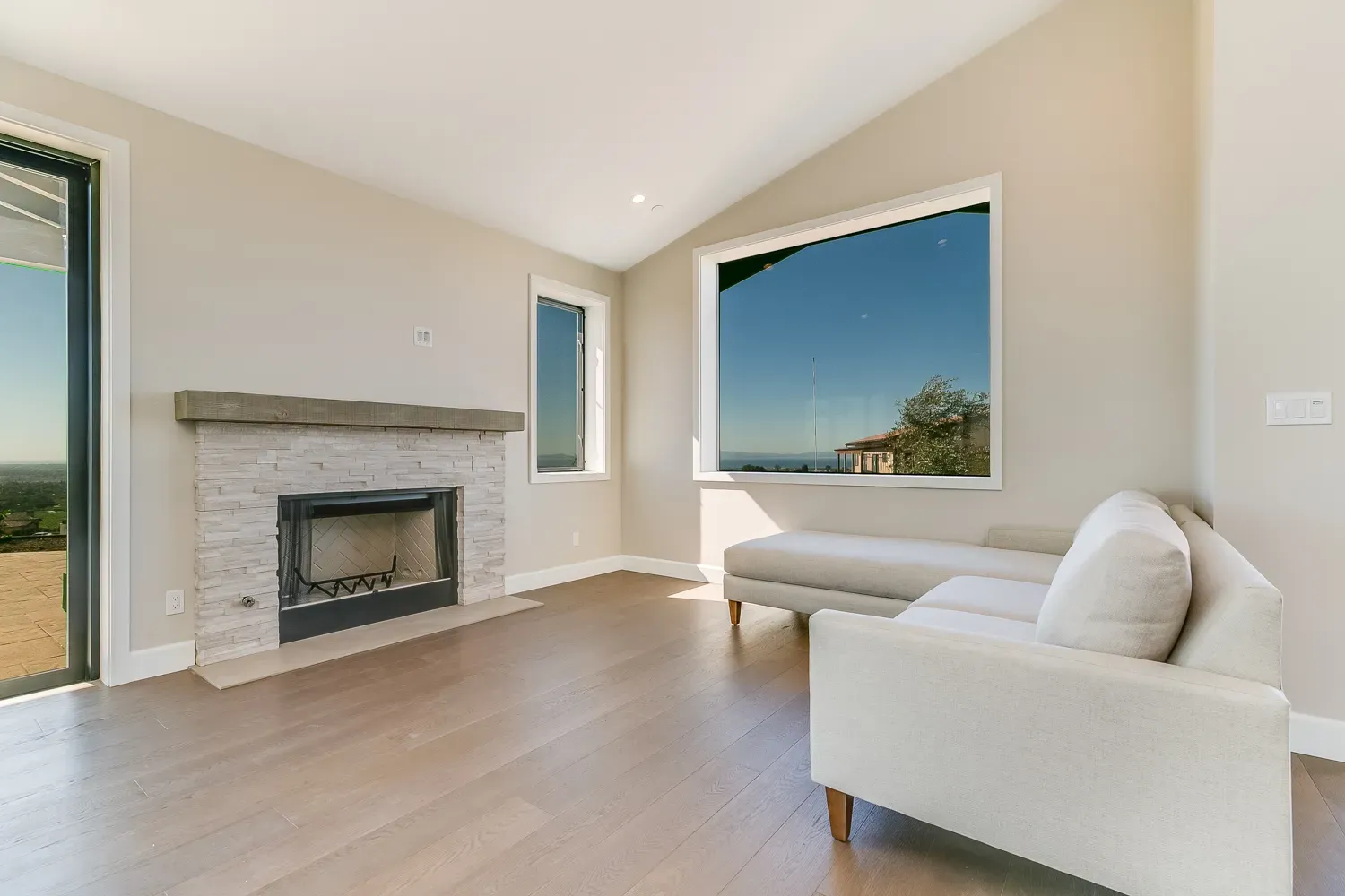 Living room with stacked-stone fireplace in the Mesa Circle home
