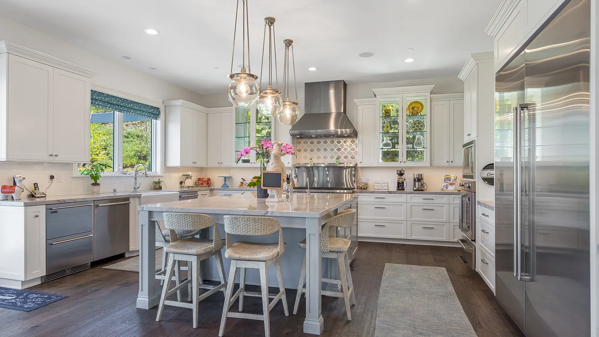 White kitchen remodel with center island and pendant lighting