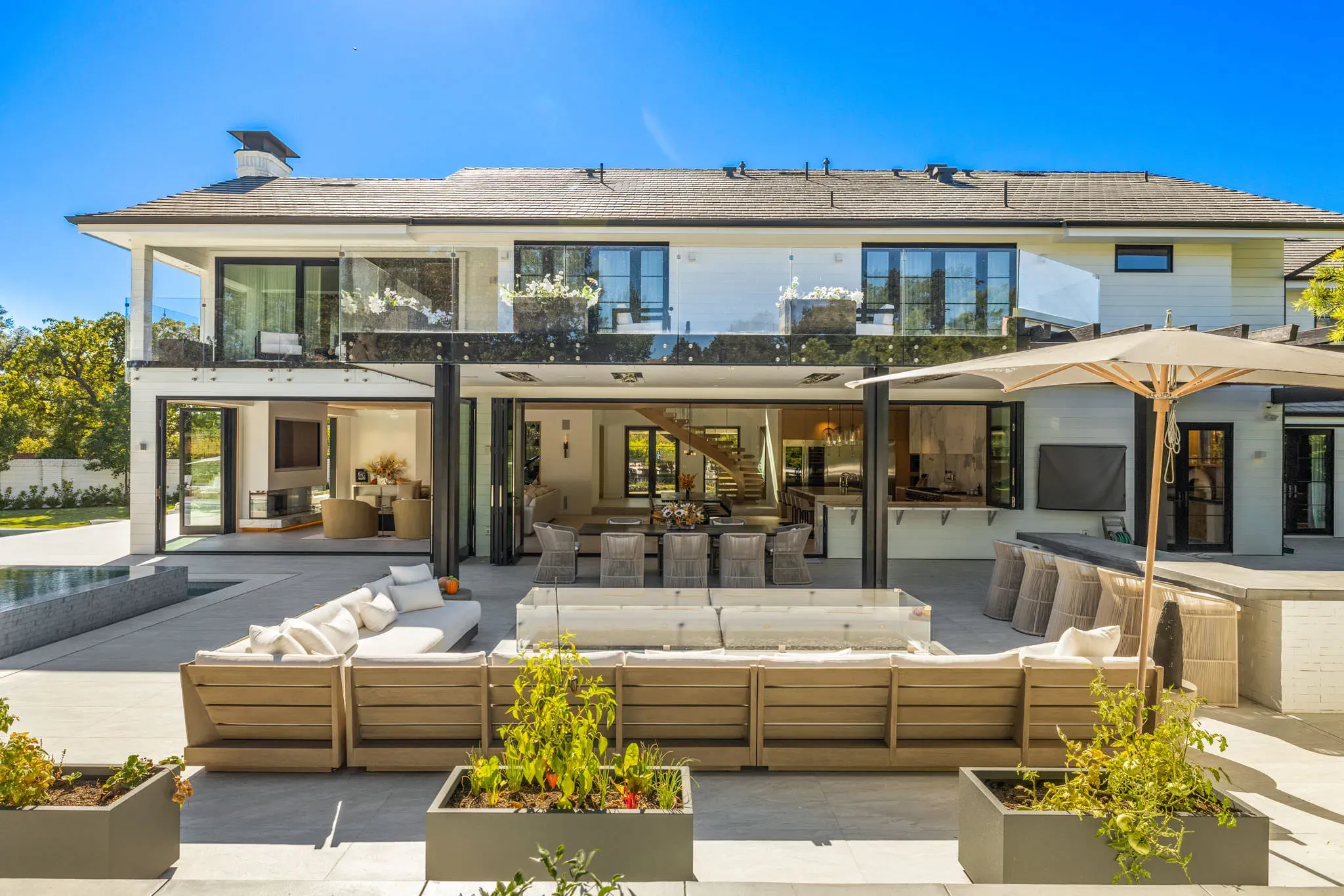 Rear elevation opened with glass to the pool and outdoor lounge