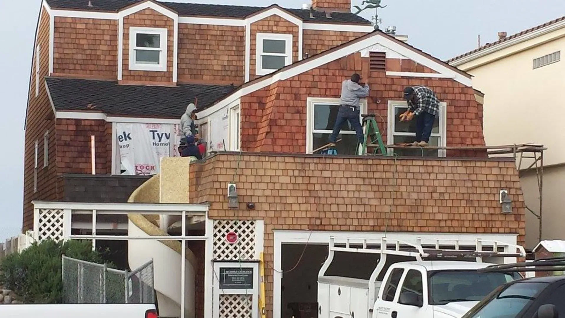 Crew working on the shingle-sided Silver Strand house during the addition