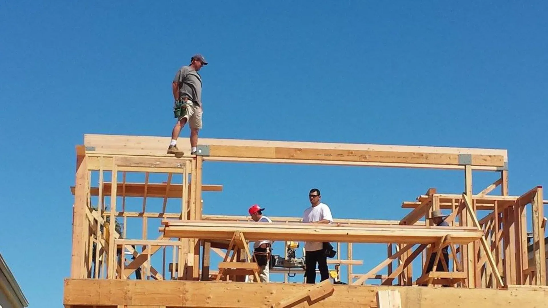 Framing crew working on the new deck level above the beach