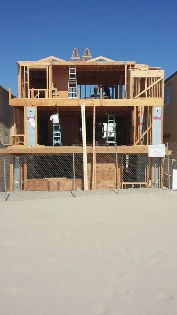 New upper-story framing rising above the sand at Silver Strand