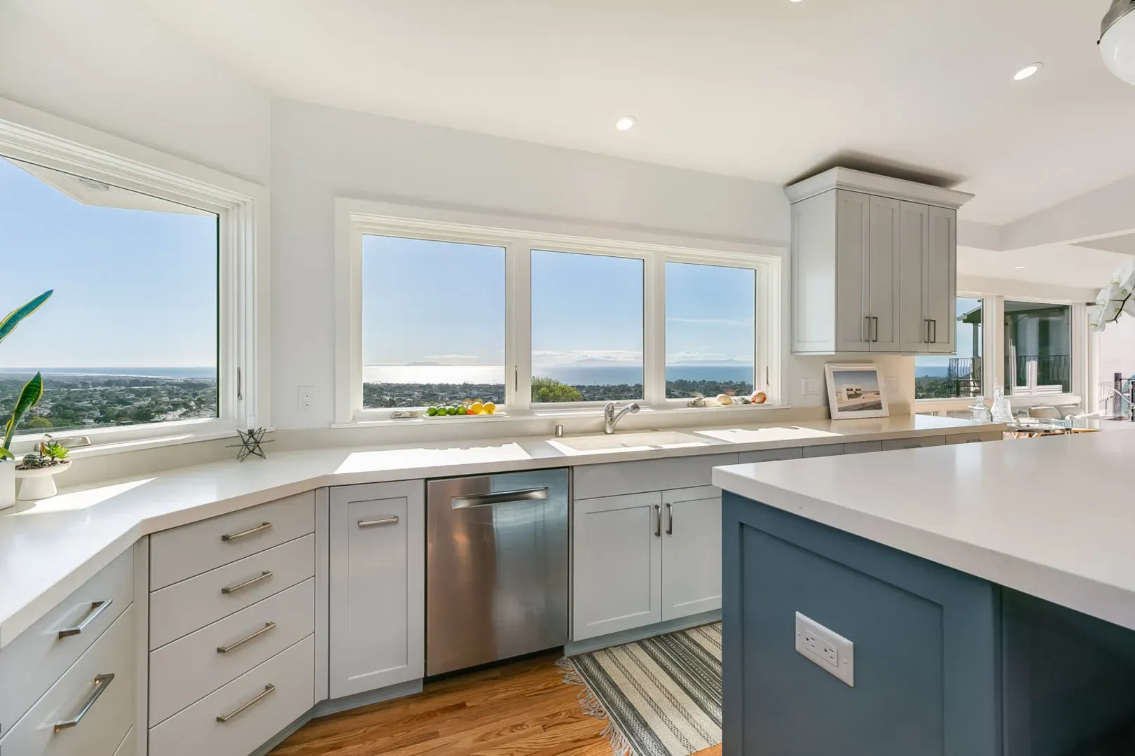 Remodeled kitchen with slate-blue island and ocean-view windows on Sunset Lane