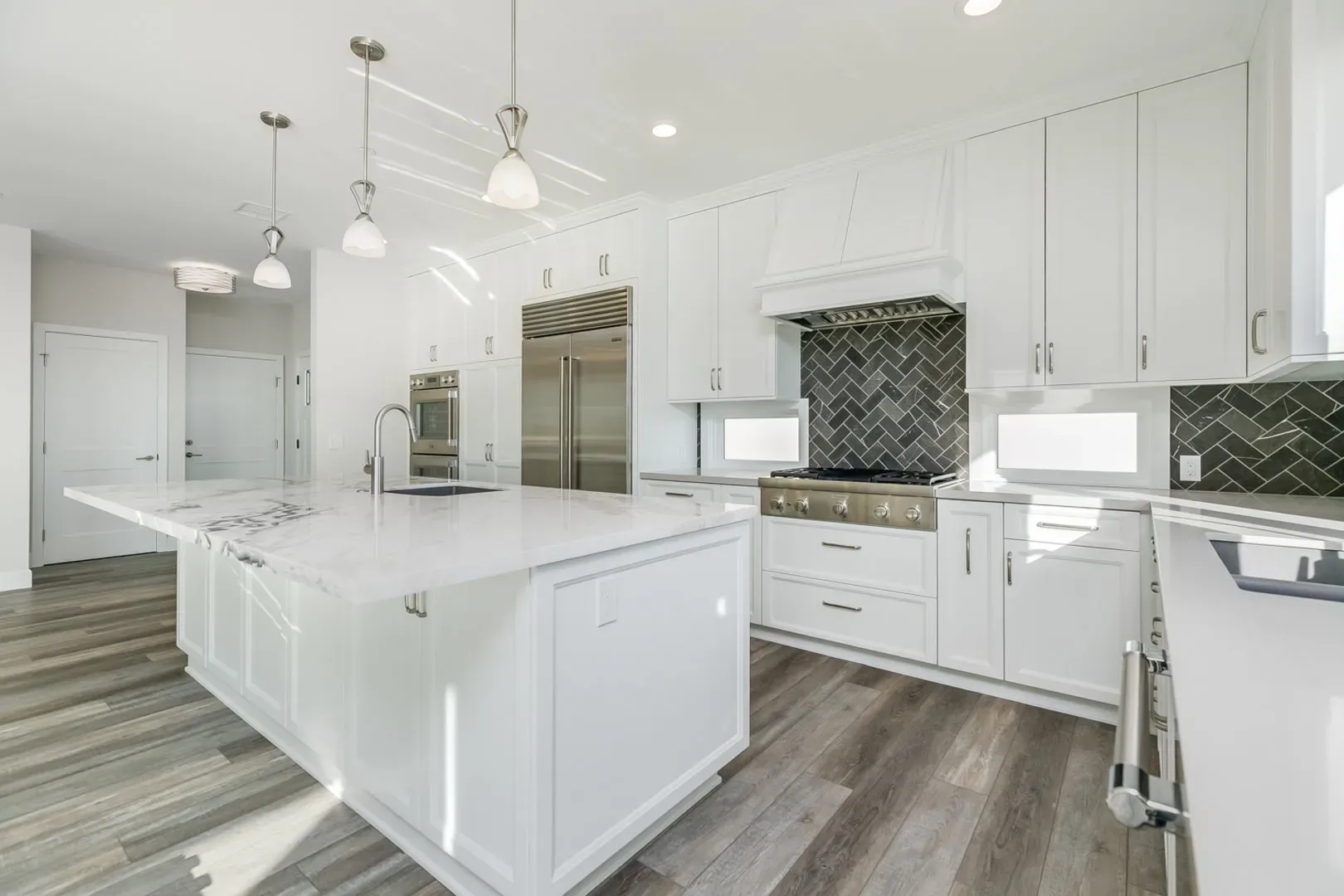 White shaker kitchen with island in the finished Ventura rebuild